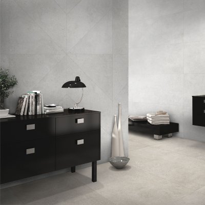 A living room scene, beautifully tiled with stunning beige Concrete Matt tiles